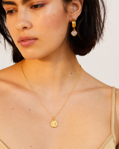 model wearingAlighieri Gold Gemini Zodiac Necklace Medallion