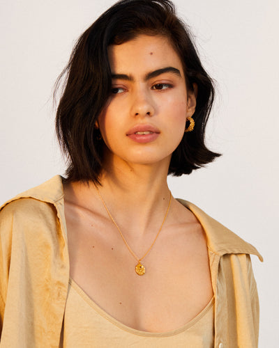 Model wearing Alighieri Gold Plated Taurus Zodiac Necklace Medallion